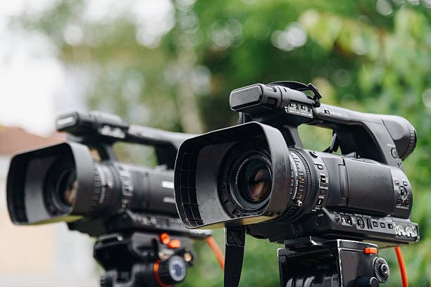 istock large black video camera on tripod outdoors 2238425926
