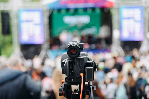 istock large black video camera on tripod outdoors 2238425950