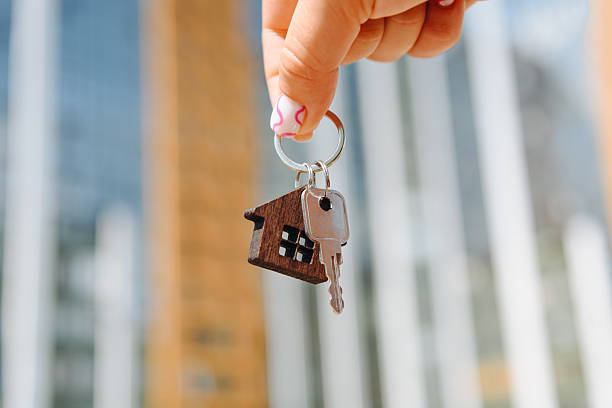 istock woman hand with new apartment key 2238425970