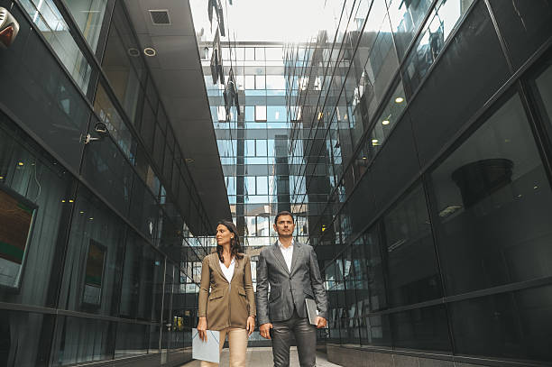 istock Business Professionals Walking Outside Modern Office Building 2238428761