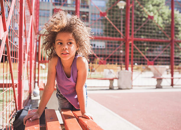 istock Curious Child Playing Outdoors on a Sunny Day 2238428943