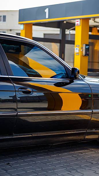 istock Black car at car wash with reflections on body 2238429271