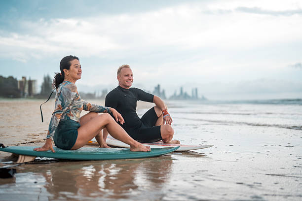 istock Joyful Surfing Couple on Gold Coast Beach 2238429469