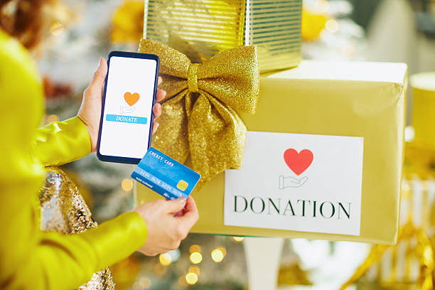 istock Online Holiday Donation with Smartphone and Gift Box 2238432858