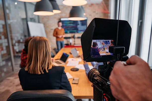 istock Capturing Corporate Dynamics: Videographer Films Business Meeting in Modern Office. 2238438151