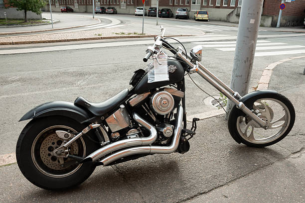 Helsinki, Finland - September 02, 2014 - Custom black chopper motorcycle parked on urban street corner.