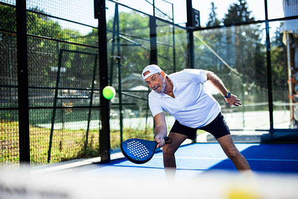 istock Senior man playing padel on a sunny court 2238443382