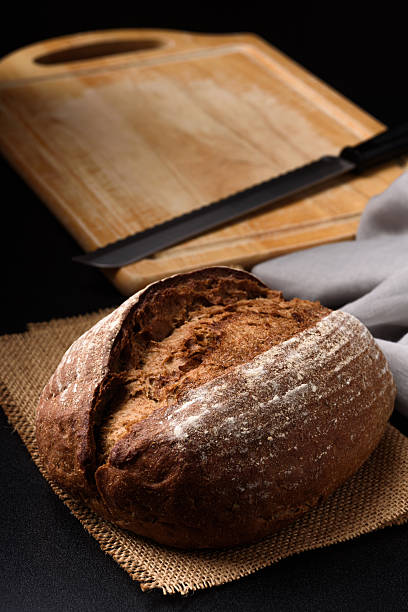 Close-up of dark rye sourdough bread on black background