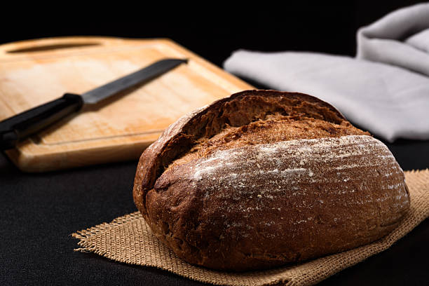 Close-up of dark rye sourdough bread on black background