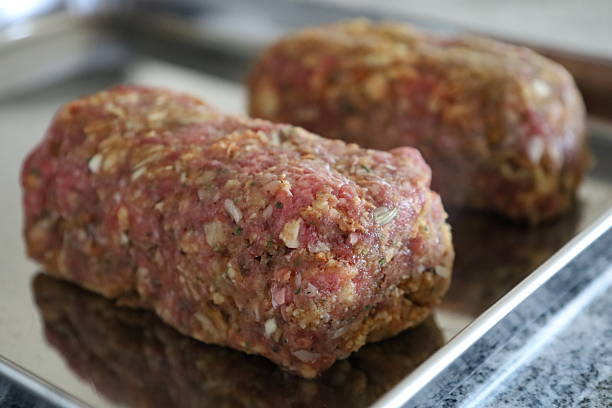 Two raw meatloafs on metal tray ready to bake in Fort Wayne, Indiana, United States