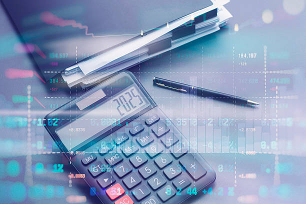 istock Digital calculator showing 2025 on display with business pen and documents with financial data overlay. Professional accounting and business analysis concept with numerical statistics and charts. 2238450203