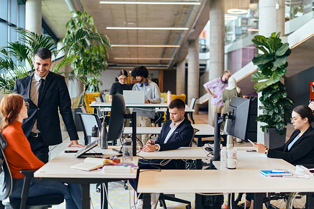 In a modern startup office, a diverse group of young professionals collaboratively tackles various business problems and challenges, surrounded by their engaged colleagues, fostering innovation and productivity.