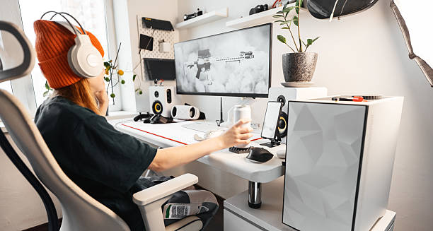 istock Competitive player gripping energy drink maintain focus during challenging gaming session. Professional setup with responsive mechanical keyboard and high-speed monitor optimizes gaming performance. 2238450744