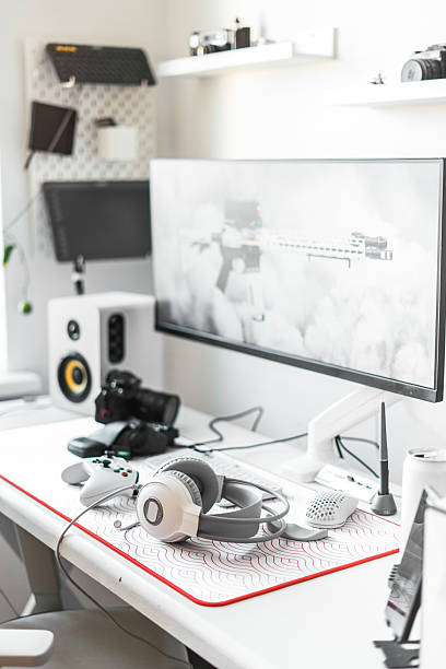 istock Minimalist workspace with advanced gaming equipment, high-performance computer, large monitor, headphones, microphone, and pc accessories. Gamers, streamers, or content creators in stylish interior 2238450807