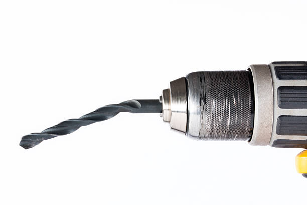Close-up of a cordless drill with a bent bit in poor condition, side view with a white background
