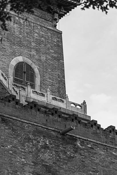 Intricate, curved wooden eaves and ornate detailing define an ancient Beijing structure exhibiting a repetitive, symmetrical pattern against a slightly overcast sky.
