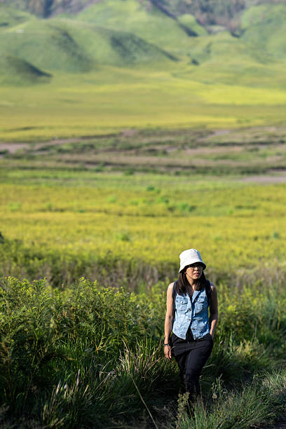 An Asian woman exploring the Mount Bromo savannah in East Java, Indonesia, Bromo National Park