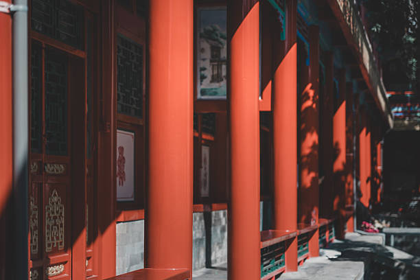 istock Intricate, ornate details of a weathered, ancient Beijing building display symmetrical patterns carved into dark wood, suggesting a traditional, historic Chinese architectural marvel. 2238456073