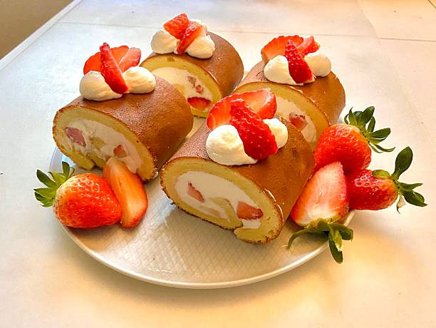 istock Soft roll cake with fluffy sponge layers and creamy filling spiraled inside, showcasing smooth texture, delicate shape, and sweet inviting appearance in close-up detail 2238460768