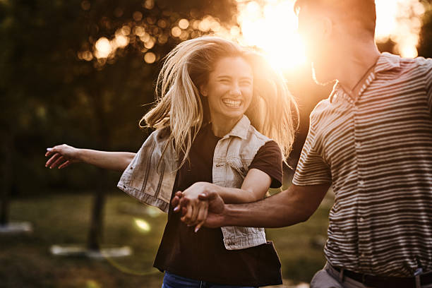 istock Cheerful couple running in the park at sunset. 2238465931