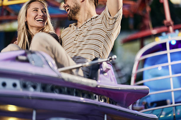 istock Cheerful couple having fun during amusement park ride. 2238465965