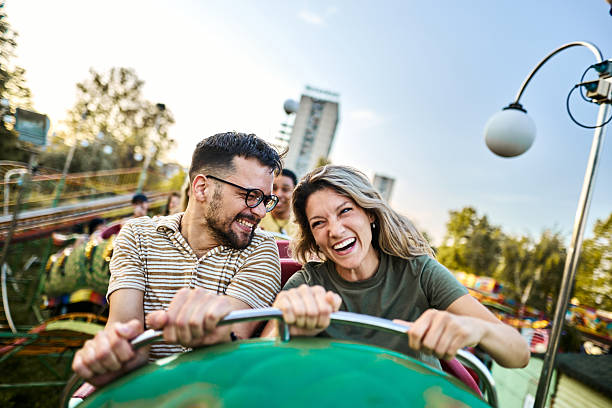 istock Young happy couple having fun on rollercoaster at amusement park. 2238466172