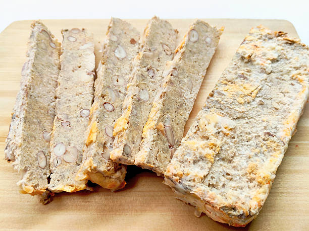 istock Southeast Asian Culinary Tradition, Sweet and Savory Oncom Slices on Rustic Wooden Chopping Block 2238466695