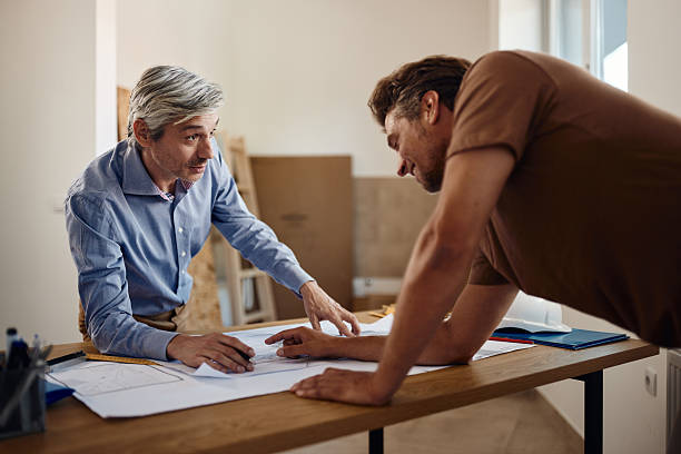 istock Male customer and architect talking about plans at construction site. 2238468039
