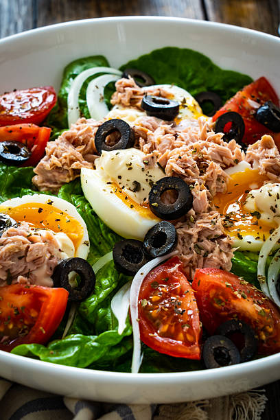 istock Tuna, boiled eggs and vegetables on wooden background 2238468390