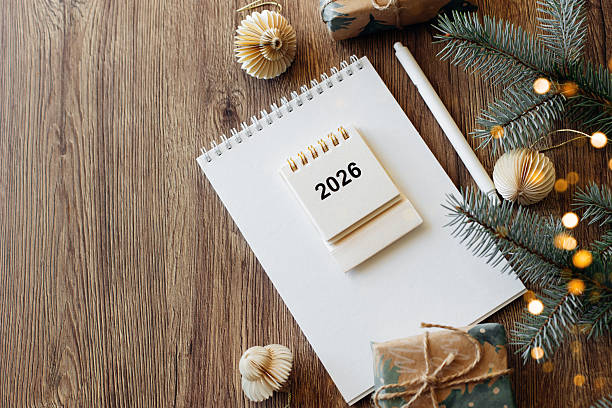 istock Festive Notepad with 2026 Calendar and Holiday Decorations on Wooden Table 2238469567