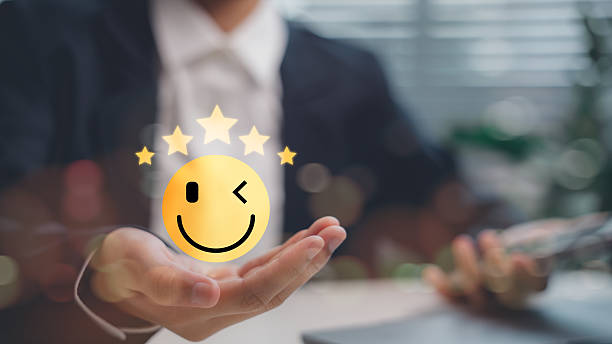 istock Customer satisfaction concept showing hand holding five-star smiley emoji icon, representing positive feedback, high rating, excellent service quality, and user experience success. 2238469575