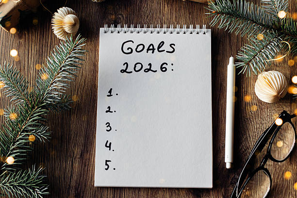istock Notepad with Goals for 2026 Surrounded by Festive Decorations and Warm Lighting. 2238469585