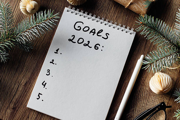 istock Notepad with Goals for 2026 Surrounded by Festive Decorations and Warm Lighting. 2238469590
