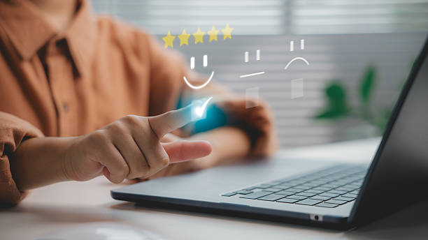 istock Customer satisfaction concept showing hand selecting five-star rating with smiley face on virtual screen, representing positive feedback, review, and user experience evaluation system. 2238470173