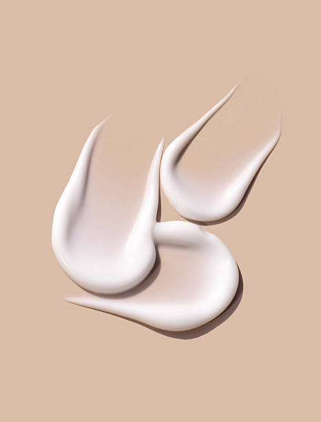 istock sample smears of creamy white texture on light beige background 2238470213