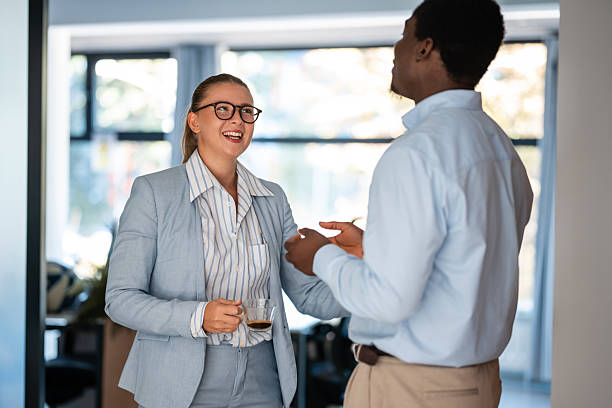 istock Business colleagues enjoying friendly conversation at office workplace 2238473749