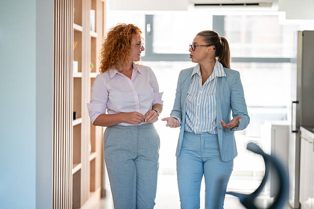 istock Professional businesswomen walking and discussing work indoors 2238473772