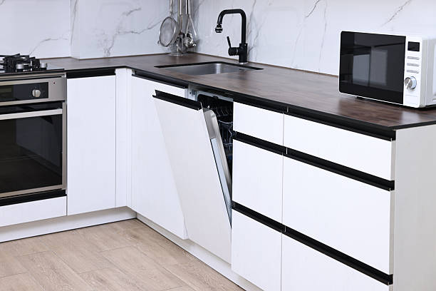 istock Built-in dishwasher with open door in kitchen 2238474512