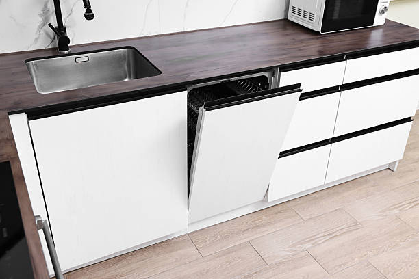 istock Built-in dishwasher with open door in kitchen 2238474520