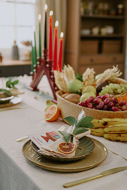 Kwanzaa Table Setting Featuring Kinara Candles and Fruit Basket Arrangement