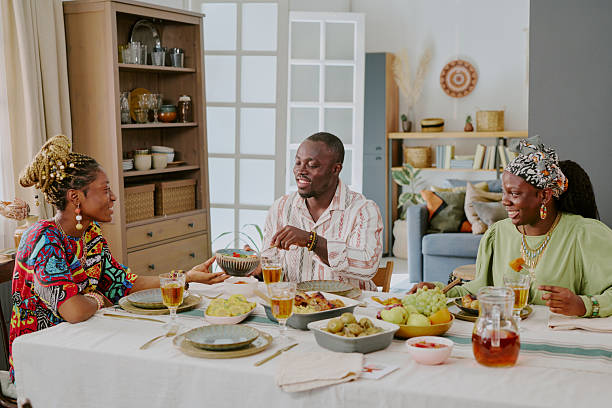 istock Black Adults Celebrating Kwanzaa Sharing Traditional Meal Around Dining Table 2238477702