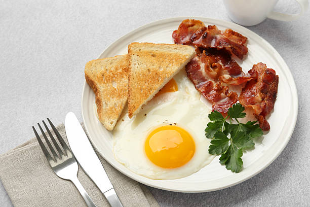 istock Delicious breakfast with sunny side up egg served on light table, closeup 2238477706