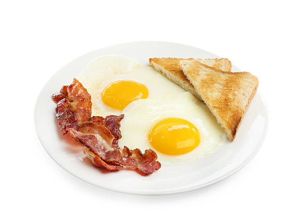 istock Delicious breakfast with sunny side up eggs isolated on white 2238477801