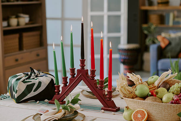 istock Kwanzaa Kinara Displaying Burning Candles Beside Fruit Basket and Gift Box 2238477827