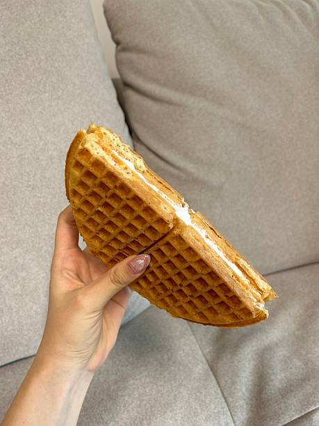 Crispy, golden waffles topped with creamy ice cream, creating a perfect balance of warm and cold, crunchy and smooth. A delightful dessert or breakfast treat, with toppings like fruits or syrup.