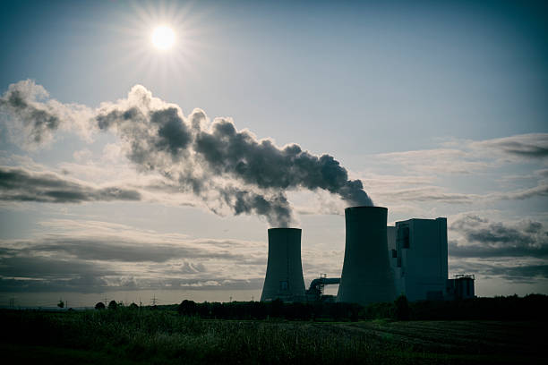 High resolution photograph of a modern brown-coal burning power plant with pollution.