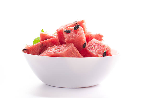 Fresh juicy watermelon pieces in a white bowl.