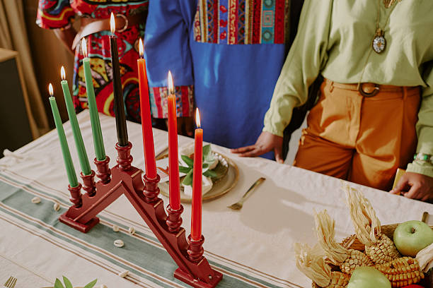 istock Diverse Young Adults Celebrating Kwanzaa Lighting Kinara Candles Together 2238478632