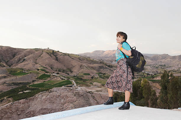 istock Mature woman traveling with backpack exploring mountains 2238480036