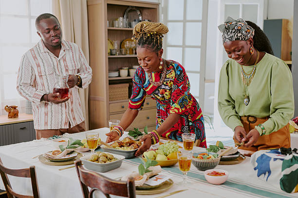 istock Black Adults Celebrating Kwanzaa by Setting Festive Table Together Indoors 2238481401